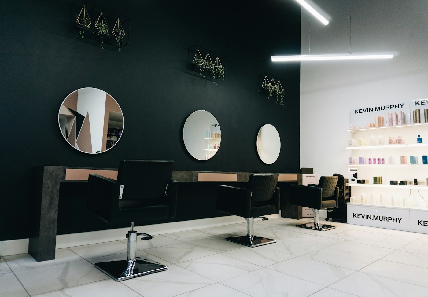 Light-filled salon with welcoming styling chairs and greenery